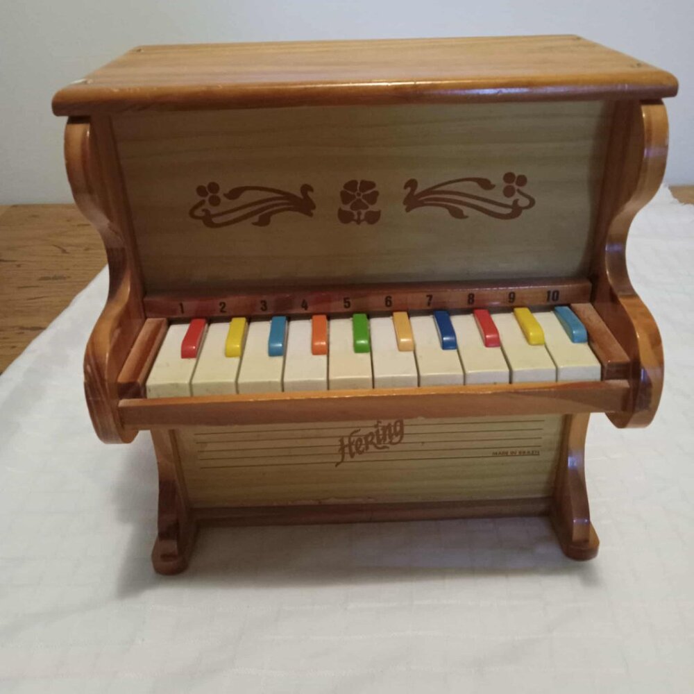 Small vintage wooden Hering piano with percussion mallets